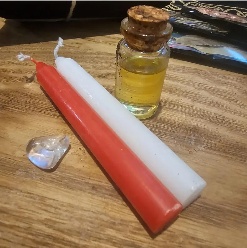 Example of part of the Yule rital kit: candles, oil, and crystal