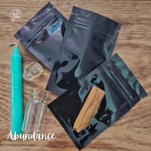 Abundance Spell Kit with green candle, herbs, citrine crystal, oil, and scroll for wealth and prosperity rituals.